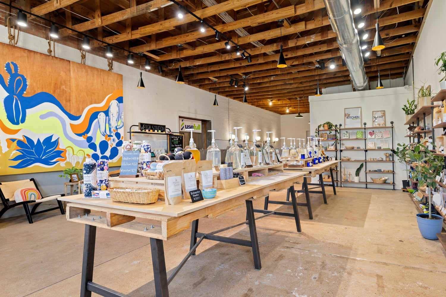 Indoors shot of a store with wooden tables, shelves displaying ecofriendly items.